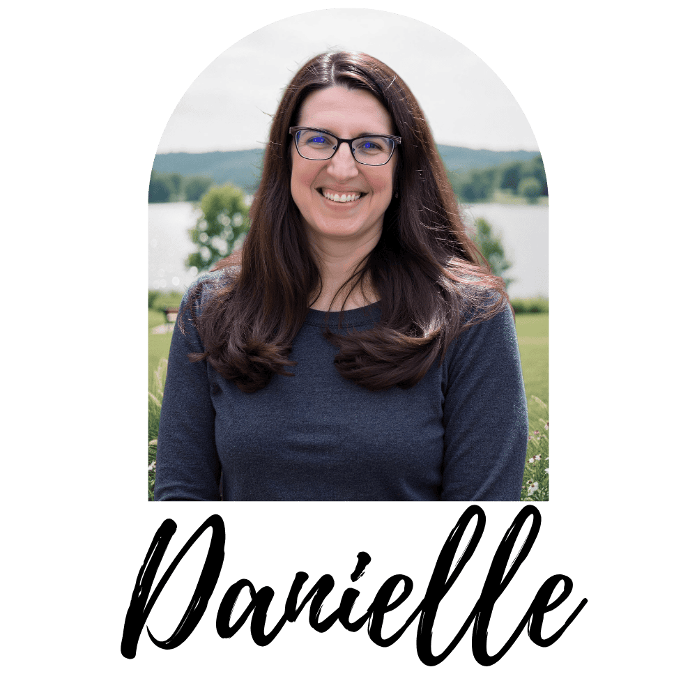 Danielle Coleman, founder of Deeper Living Adventures, smiling outdoors — arch framed headshot with signature